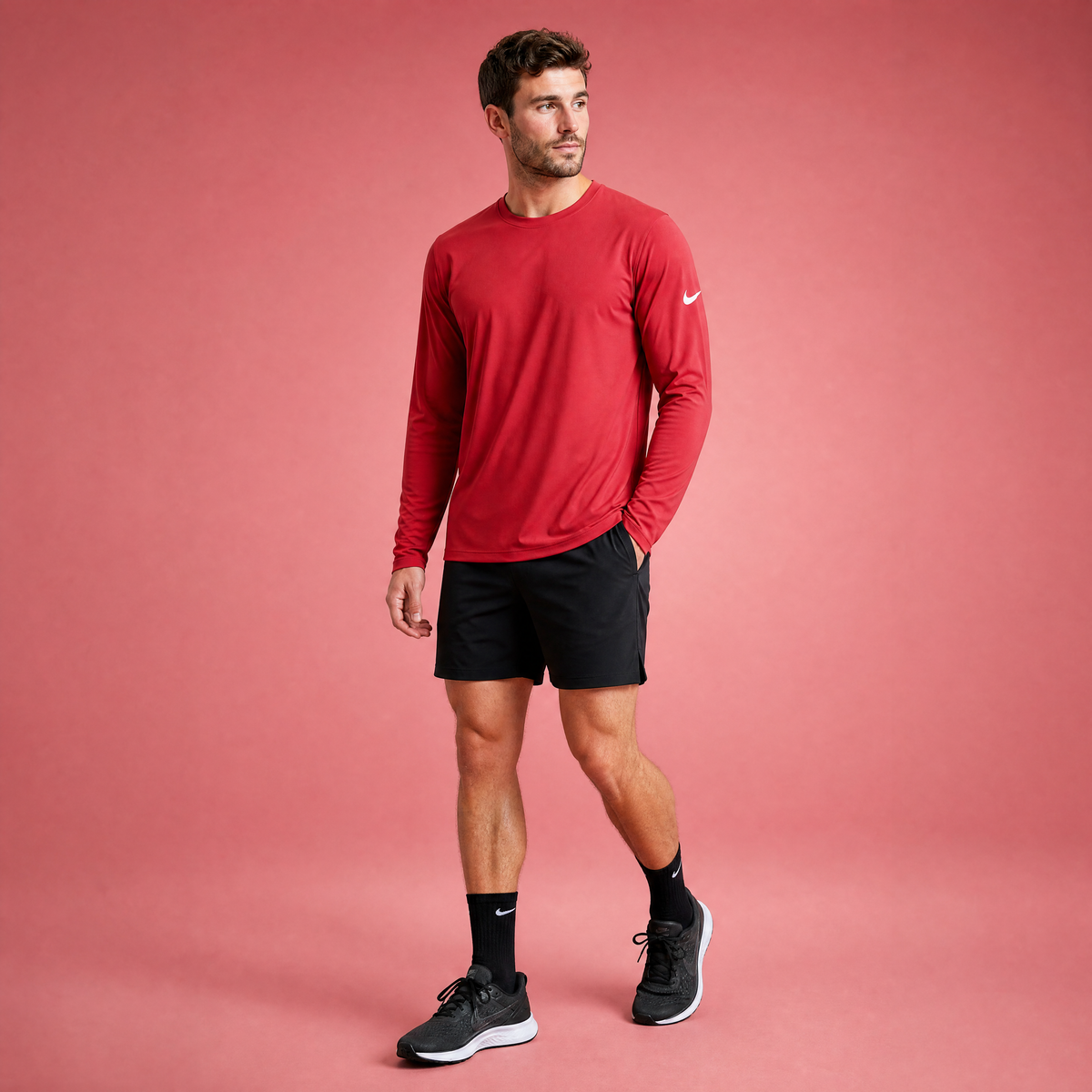 Male athlete modeling the red Nike Cotton Long Sleeve Men's Tee
