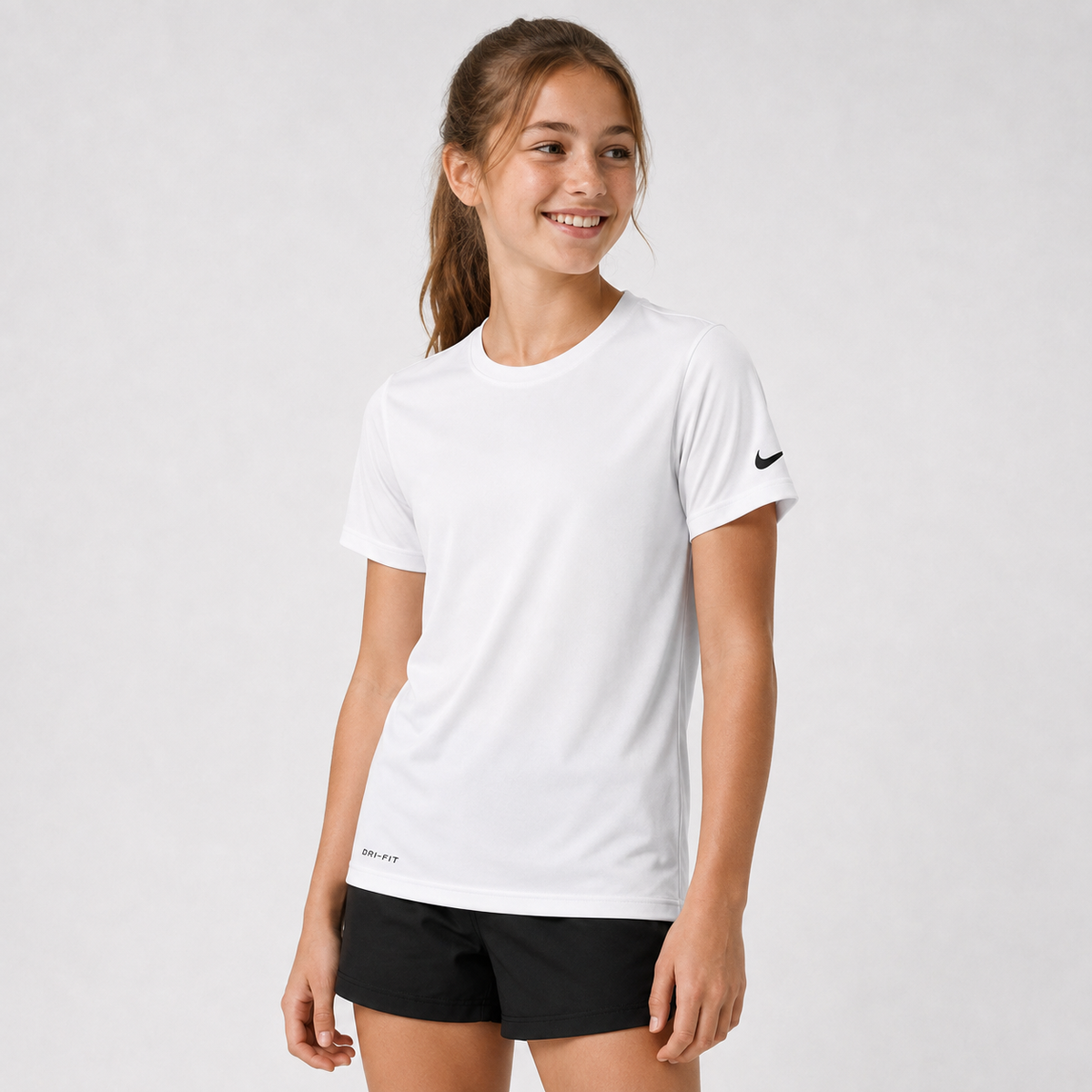Youth athlete wearing the Nike Youth Dri-Fit Short Sleeve Cotton Shirt